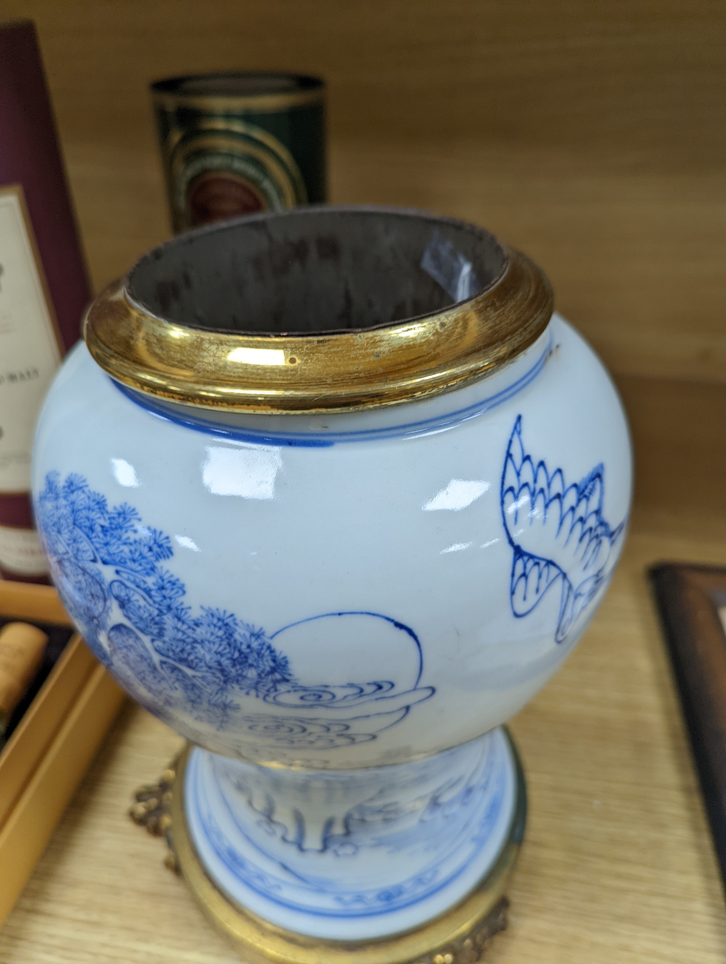 A Chinese blue and white baluster vase, brass mounted 29cm